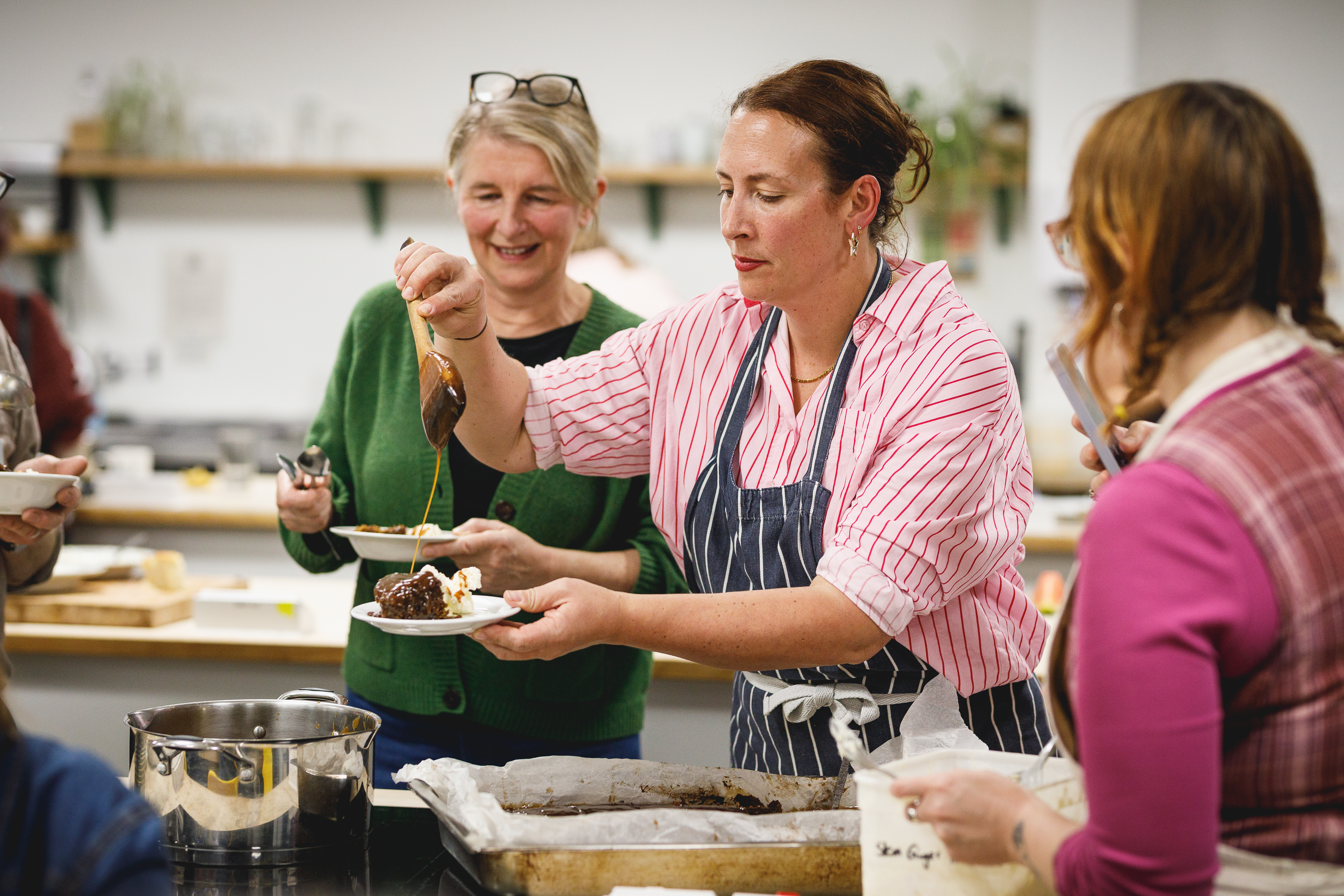 Charlotte serving pudding to guests.jpg